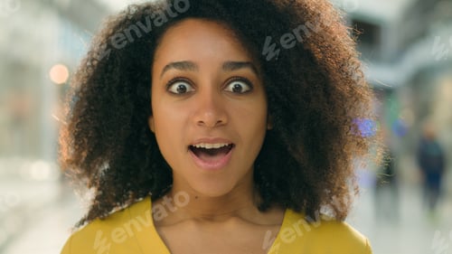 Preview: Close up happy excited African American woman black friday sale shopping mall shocked client store
