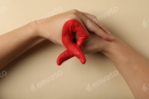 Preview: Two hands depict AIDS awareness sign on beige background, copy space