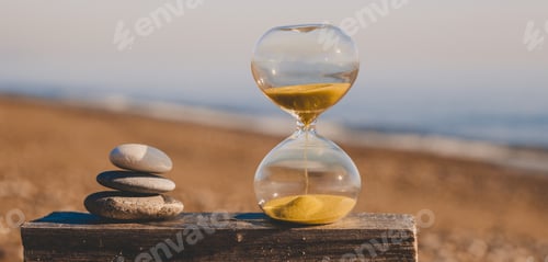 Preview: Hourglass on a wooden board with three stones