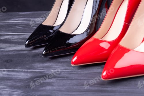 Preview: Close up shiny female red and black high heel shoes.