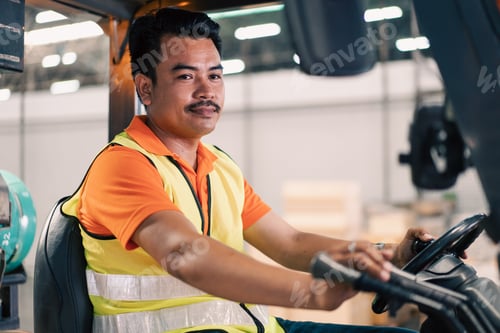 Preview: Asian male driver driving forklift to shipping delivery in the warehouse distribution