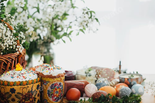 Preview: Easter modern eggs, cake, ham, beets, butter in rustic basket decorated with green buxus branches