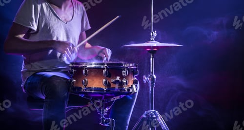 Preview: A drummer plays drums on a blue background.