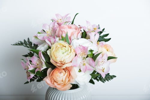 Preview: Beautiful colorful flowers in bloom in white vase.