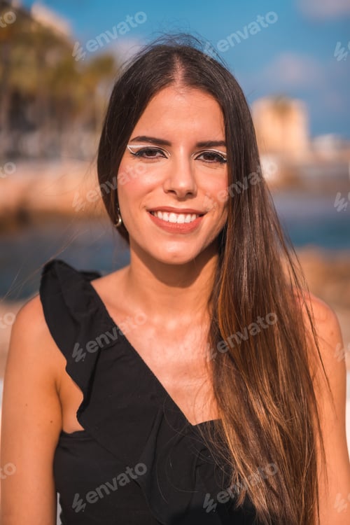 Preview: Summer lifestyle, a young brunette Caucasian woman enjoying the coast sitting by the sea