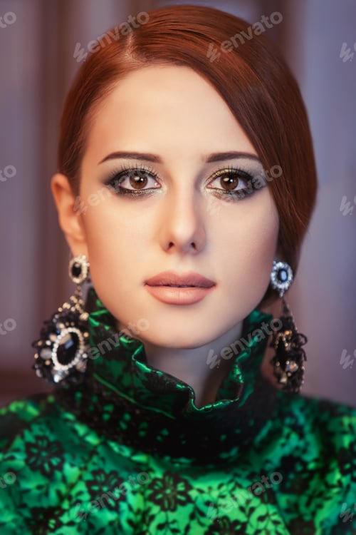 Preview: Portrait of a beautiful redhead women with earrings.
