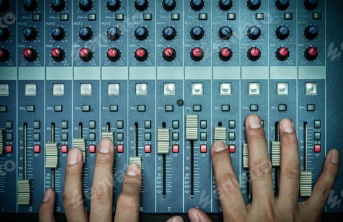 Preview: Top view of Hands adjusting audio mixer, music instrument concept