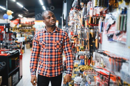 Preview: African american man standing in hardware store