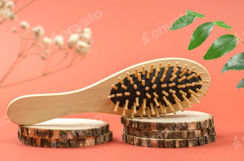 Preview: Wooden comb on a wooden podium. Hair care with natural accessories. Zero waste, no plastic