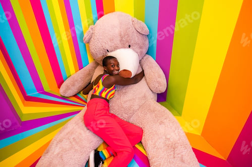Preview: Beautiful young woman having fun inside a rainbow box room