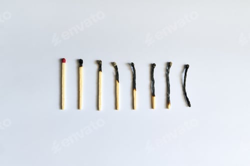 Preview: Burnt matches over white background