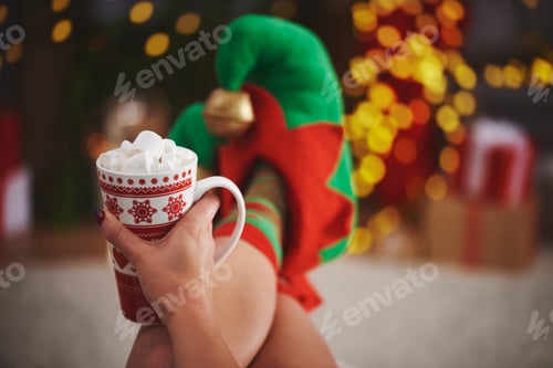 Preview: Woman wearing elf slippers holding hot chocolate