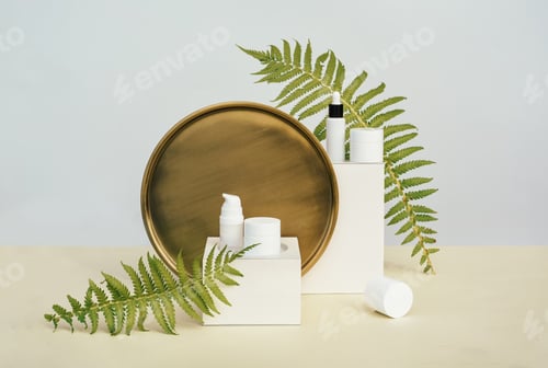 Preview: Different packages of natural cosmetics, serums on podiums with tropical leaves