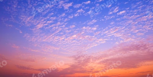 Preview: Dramatic evening sky background with many fluffy clouds on colorful sunset sky in panoramic view