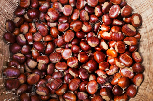 Preview: A basket of roasted sweet edible chestnuts.