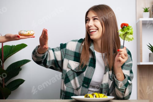 Preview: Young pretty woman adheres to diet and chooses healthy food