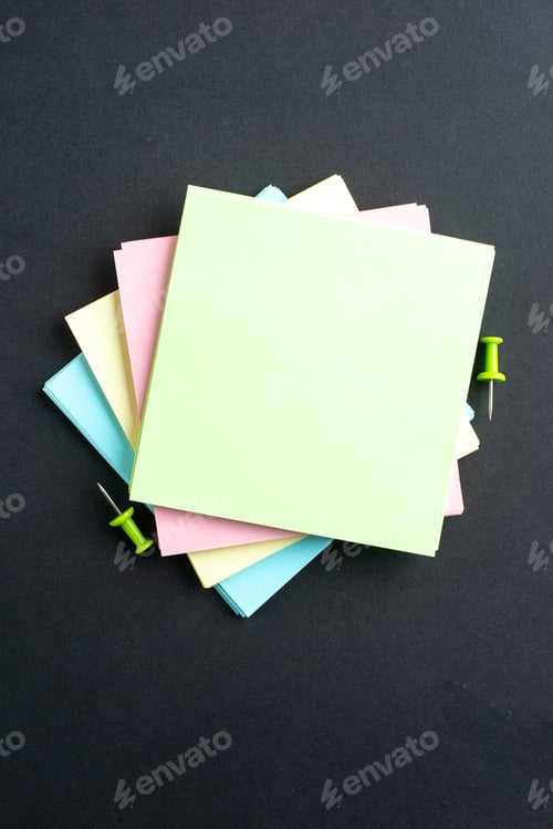 Preview: Vertical view of stacked sticky note cubes on isolated black background with free space