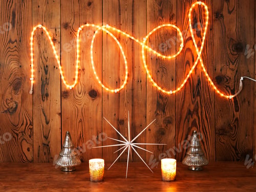 Preview: Christmas lights spelling Noel against wood panelling