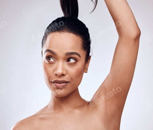 Preview: Studio shot of a beautiful young woman posing against a grey background