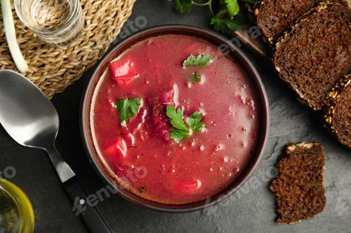 Preview: Stylish brown clay bowl with Ukrainian borsch on black table, flat lay