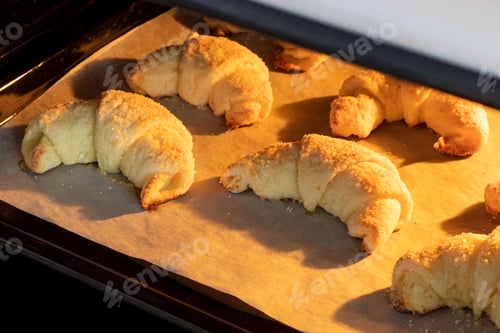 Preview: Oven-baked sugar-frosted croissants on baking sheet baked in a hot oven