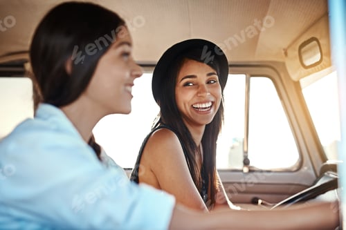 Preview: Road trips are always a good idea. Shot of two happy young friends going on a road trip.