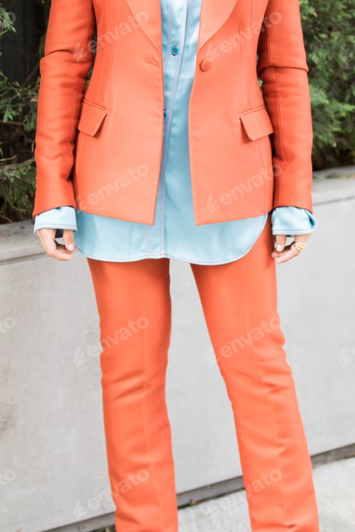 Preview: model wearing a pair of orange trousers, an orange jacket and a denim shirt