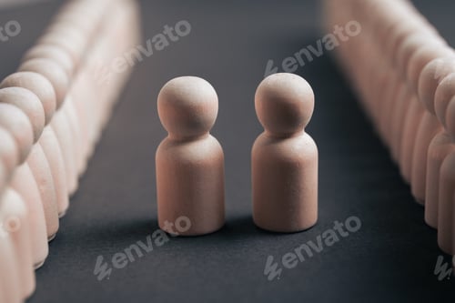 Preview: Two Wooden Figures Representing Leaders Meeting for Negotiation in Corporate Setting