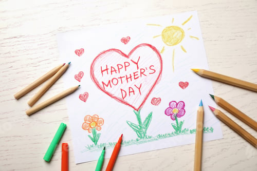 Preview: Flat lay composition with handmade greeting card for Mother's Day on light wooden table