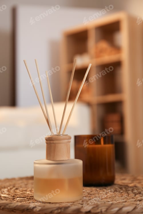 Preview: Aromatic reed air freshener and candle on wicker tray in room
