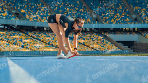 Preview: Sportswoman stretching before run on stadium