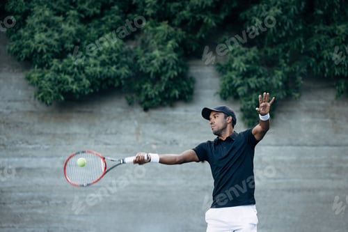 Preview: Professional tennis player hitting a ball with racket