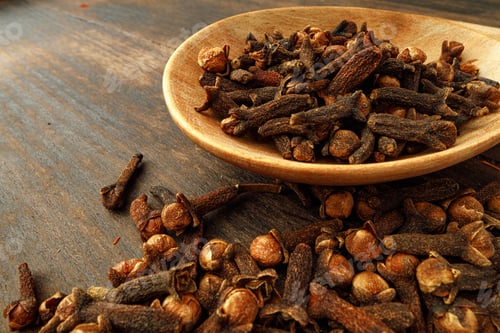 Preview: Heap of clove spice on wooden table