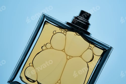 Preview: A bottle of perfume with a spray gun on a blue background with an illuminated texture.