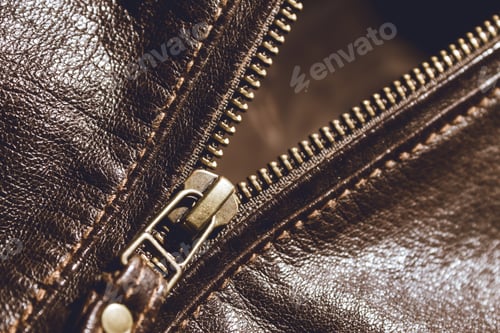 Preview: Brown leather texture and metal zipper . Fragment of leather jacket