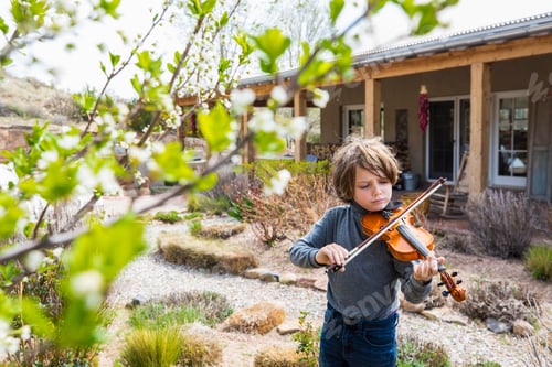 Preview: 6 year old boy playing violin outside of his home