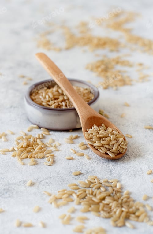 Preview: Brown rice in a wooden bowl with a spoon