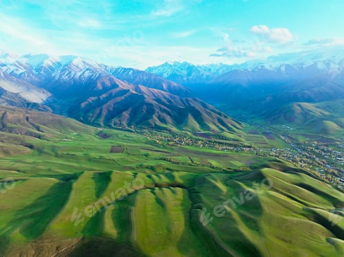 Preview: Bright Green Contoured Hills and Snowy Peaks