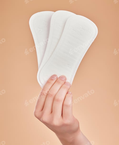 Preview: Hand, sanitary pads and period with a woman in studio on a brown background for female hygiene or c
