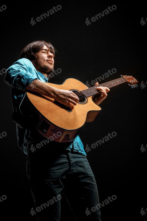 Preview: Cool Guy Standing With Guitar On Dark Background