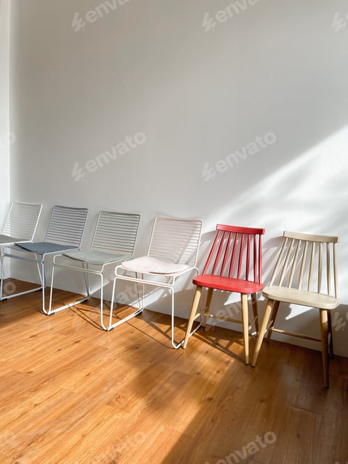 Preview: Empty chairs and table against wall at cafe