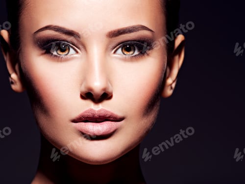 Preview: Close-up face of a beautiful sexy woman with brown make-up of e