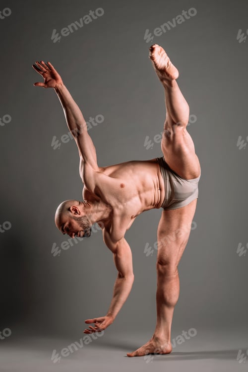 Preview: Strong beard man doing dance pose on barefoot near wall
