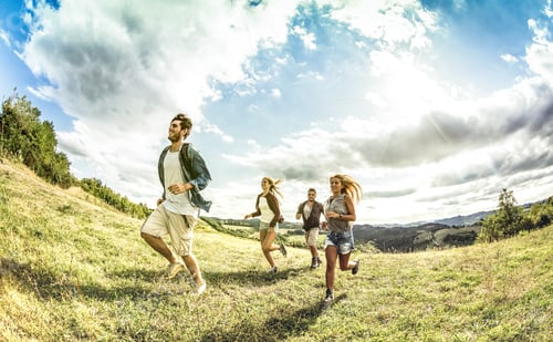 Preview: Group of friends running free on grass meadow