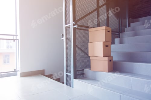 Preview: Moving boxes on stairs in house.