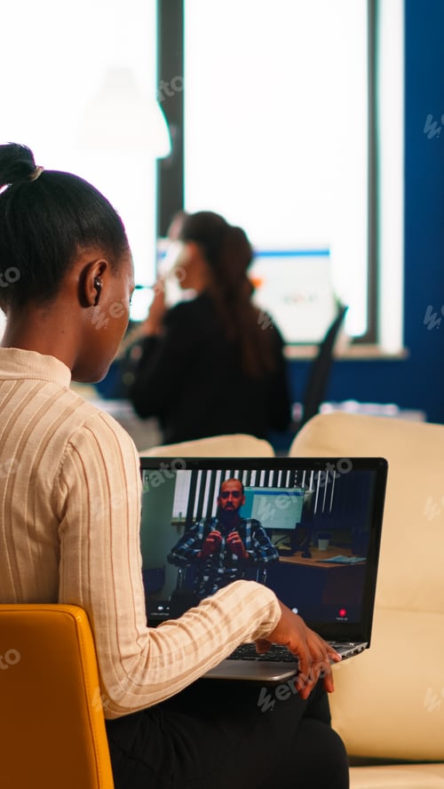 Preview: Black woman discussing with remote disabled colleague using video call