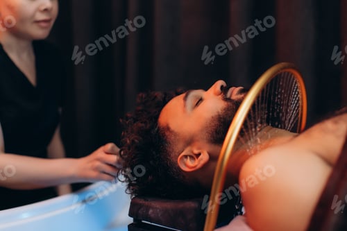 Preview: Man enjoying head spa treatment for hair and scalp wellness. Japanese spa head