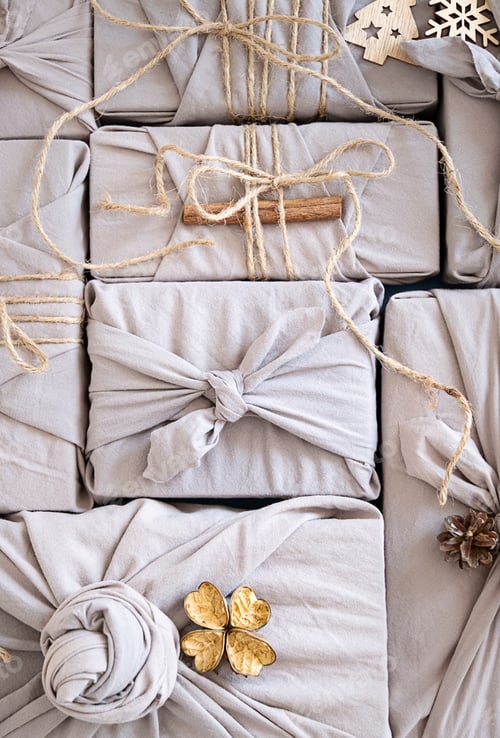 Preview: Sustainable Christmas gift wrapping with furoshiki cloth and natural decor.