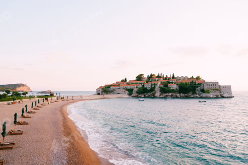 Preview: Sandy spit with sun loungers near the isthmus of the island of Sveti Stefan. Montenegro