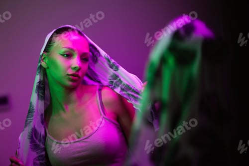 Preview: Young Woman With Scarf Under Neon Lights